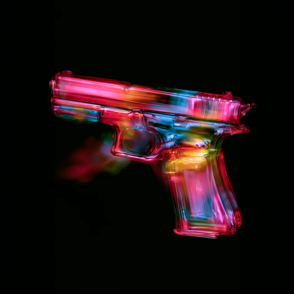 A pistol rendered in glass, lit through in pink and cyan against black